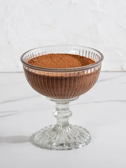 Our Dark Chocolate Mousse in a glass goblet, a simple yet profoundly rich dessert with a smooth, velvety texture.