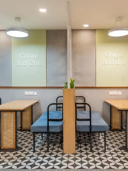 Another view of the finished breakout zone, showcasing the "Coffee and Chill" and "Chips and Dip" wall art that adds a fun, relaxed vibe to the space.