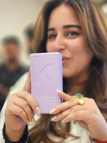 A happy client showing off her favorite Kevin Murphy product. I always recommend the best take-home care to maintain your salon-fresh look.