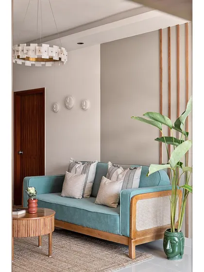 This shot captures the full effect of the feature wall in 'The Boho Escape', with its mix of paint, wood battens, and a sculptural light fixture.