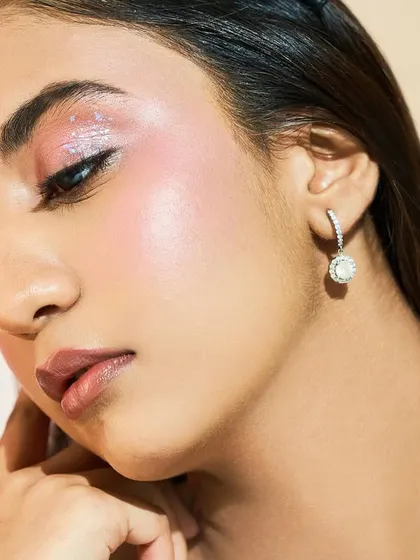 A beautiful portrait showcasing the glowing skin and glossy lips that complete this stunning look.