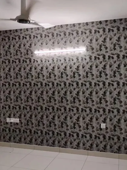 A dark wallpaper with a subtle, abstract leaf pattern. The monochrome design adds texture and a modern, sophisticated feel to this empty room.