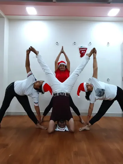 Another fun Christmas celebration pose. These moments of creativity and teamwork build a strong bond within our yoga family.