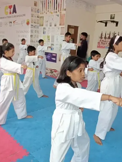 Students practicing a basic punch from a walking stance, a fundamental offensive move.