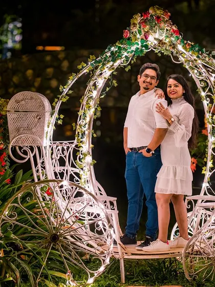 Posing with the illuminated Cinderella carriage at night. This setup is perfect for creating a whimsical and unforgettable fairy-tale portrait.