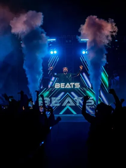 The view from my console at the JNC festival. The stage setup with my custom "BEATS" branding, CO2 cannons, and a crowd ready to party.