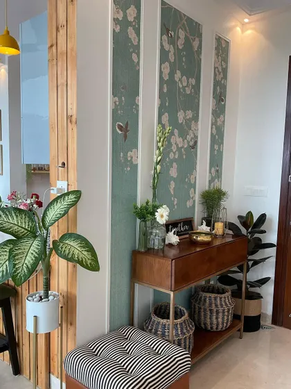 This foyer uses vertical wallpaper panels and a sleek console table to create a space with personality and functionality.