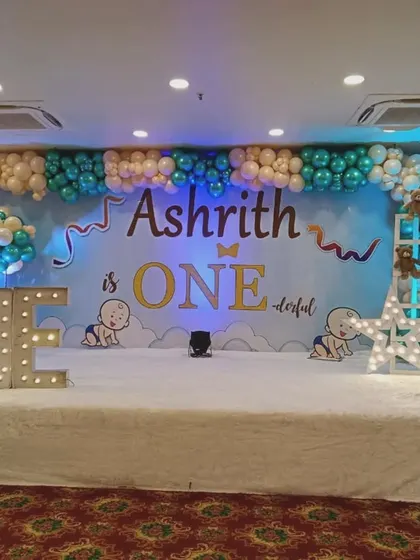 A stage decoration for Ashrith's "ONE-derful" first birthday. While I specialize in newborn events, I also create fun setups for first birthdays, like this one with marquee lights and cute illustrations.