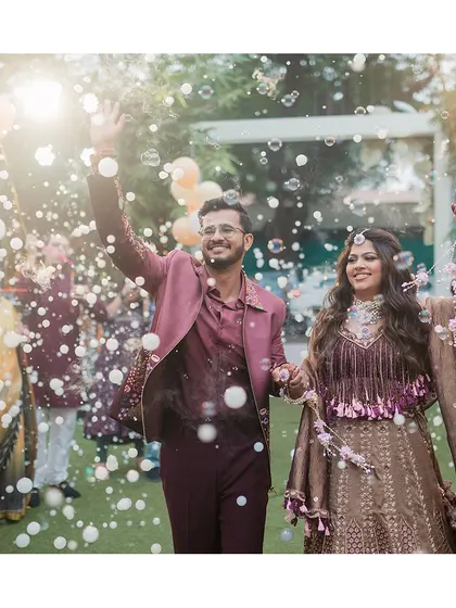 A magical entry for the couple at their Phoolon Ki Holi, surrounded by friends, family, and a cloud of bubbles.