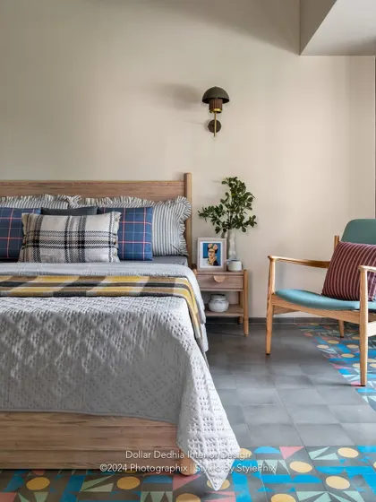 A cozy corner in another bedroom from the Panchgani villa. I mixed plaid and striped cushions for a touch of rustic charm, while the colorful geometric floor tiles add a playful, modern twist.