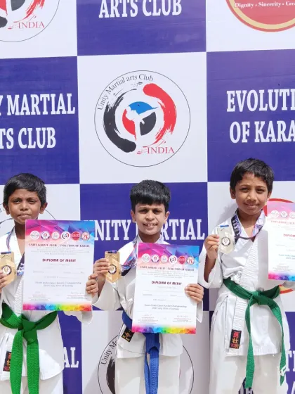 Three of my young students, beaming with pride as they display their medals and certificates from the South Indian Open Karate Championship.