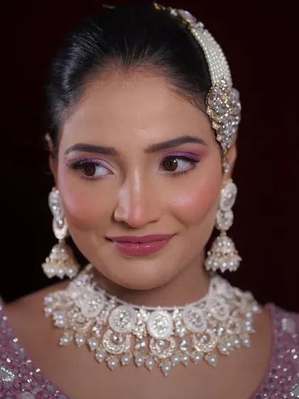 A close-up portrait showing the details of the eye makeup and the beautiful jewelry.