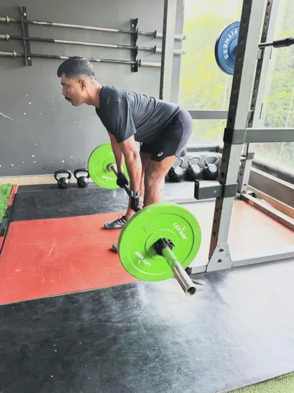 A client performs a deadlift with excellent form, a result of consistent coaching and practice.