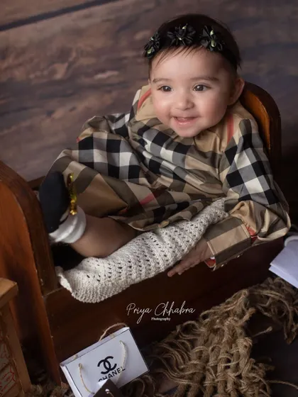 A close-up portrait from the designer-themed session, capturing a happy and content smile.