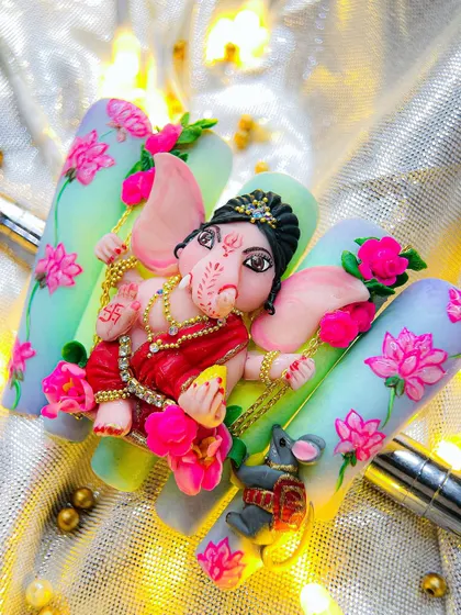 A different angle of the incredible 5D Ganesha nail art, showing the depth and detail of the sculpted figure and the hand-painted lotus flowers.