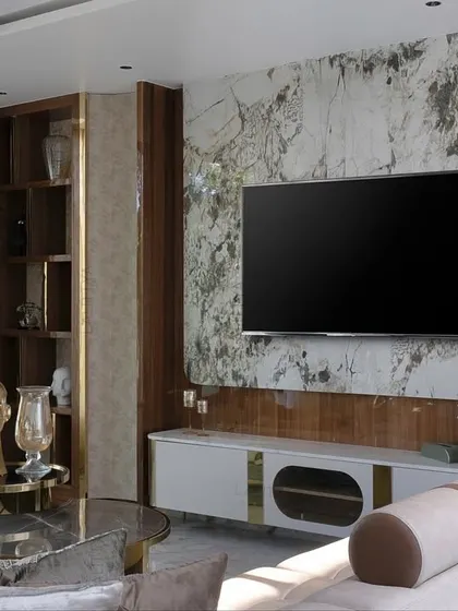 Another angle of the lounge, showing the comfortable sectional sofa and the curated decor pieces. The color palette is kept neutral and calming, allowing the natural view and the texture of the materials to take center stage.