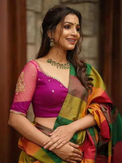 A repeat of the magenta blouse with sheer embroidered sleeves, paired with a green beaded necklace.