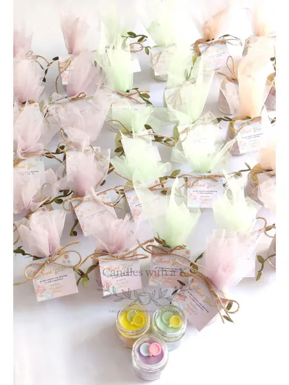 The full order of 'Teddy in the Clouds' themed baby shower gifts. The soft pastel colors of the net wrapping create a dreamy and cohesive look for the party favors.