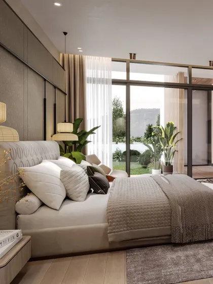 This angle captures the view from the bed to the garden, with large glass doors blurring the line between indoors and outdoors.