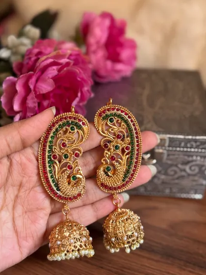 A still shot of our peacock ear cuffs with red and green enamel. The matching jhumkas are intricately designed as well.