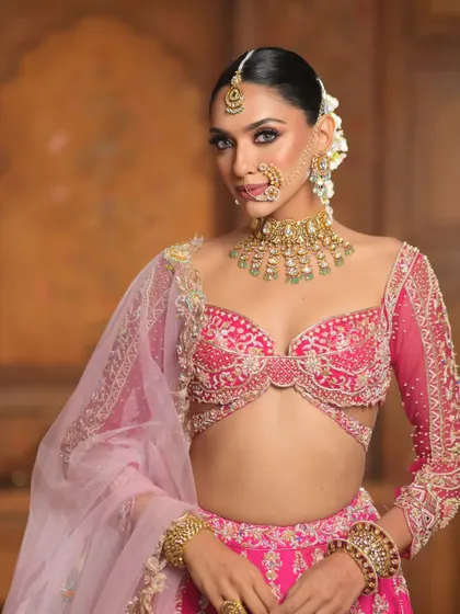 A fairytale look brought to life. This bride is a vision in pink, with makeup that features dramatic winged eyes, soft pink eyeshadow, and a flawless complexion.