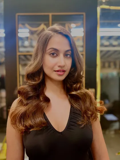 A beautiful example of a soft, warm brunette color with subtle highlights. The bouncy curls add glamour and volume to the final look.