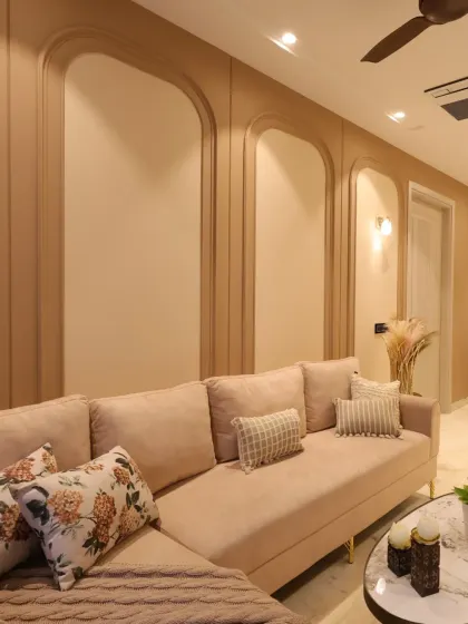 A close-up of the L-shaped lounger sofa against the arched wall panels, showcasing the comfortable and inviting design of the family lounge.
