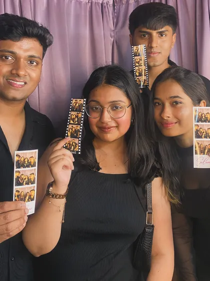 A group of friends at RRMC, each holding their own copy of the photo strip. No one gets left out!