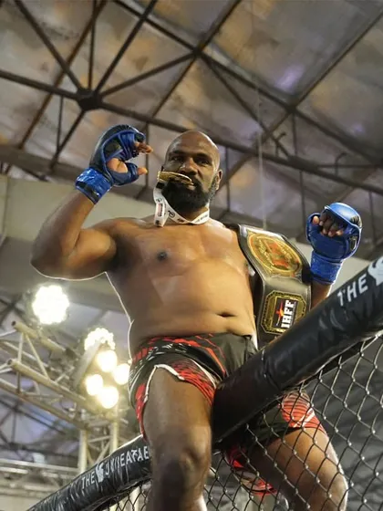Posing with the belt in the octagon. This is the result of countless hours of training, sacrifice, and an unbreakable will to win.