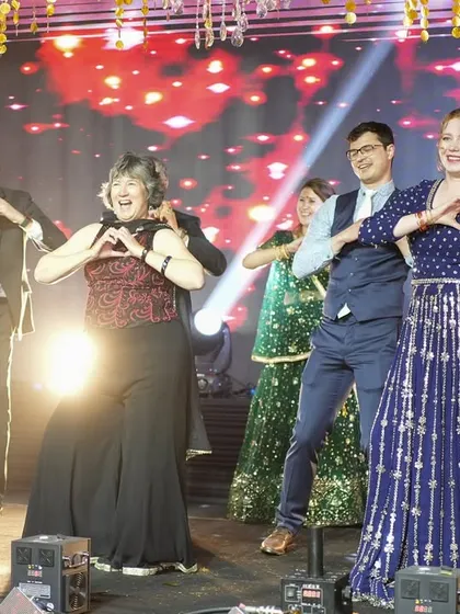 A sweet choreographed moment with the family. We create simple steps that everyone can do together, making for a perfect photo opportunity and a cherished memory.