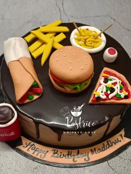 A foodie's dream cake! This Dutch truffle cake is topped with handmade, edible miniatures of a burger, pizza, fries, and more.