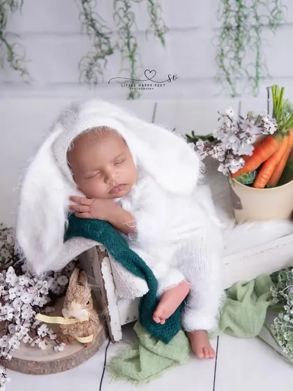 Our little bunny is ready for his carrots! This is a wider shot of the theme, showing the full setup with a crate of carrots and other rustic, garden-inspired props.