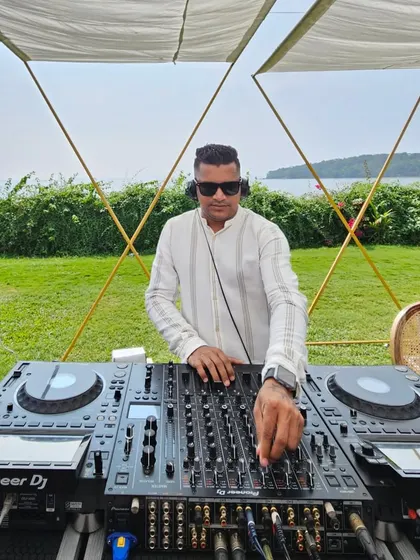 Mixing tracks at the Goa brunch party. I always dress to match the occasion, whether it's a casual beach shirt or a formal suit for a reception.