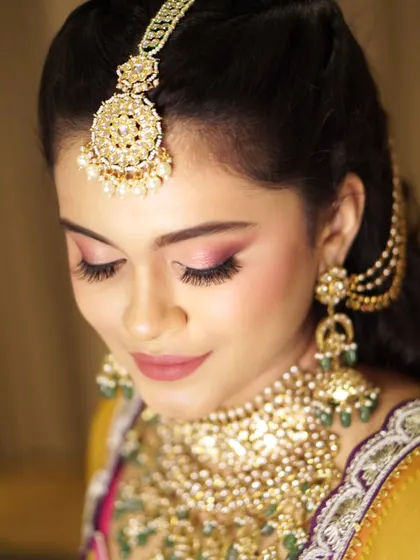 Soft rose tones and weightless lashes create a look that is both romantic and elegant. This eye makeup enhances the bride's features without overpowering her natural beauty.
