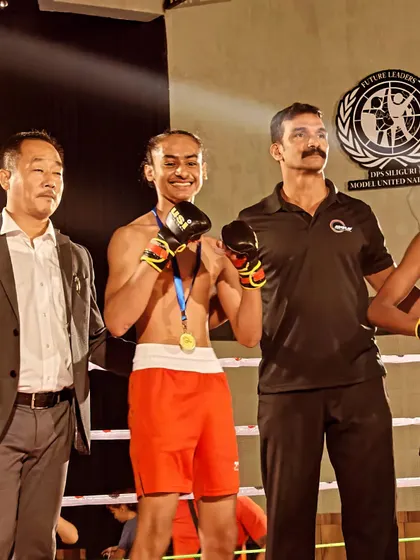 A champion's smile. Kartar Singh with his gold medal after a dominant performance.