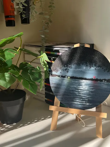The round nightscape painting on a mini easel in my studio.