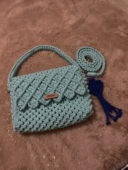 This mint green version of the scalloped flap bag is so fresh and pretty. It comes with a matching strap and a contrasting blue tassel.