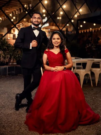 A perfect prince and princess moment. Her classic red ball gown and his sharp tuxedo create a timeless and romantic look for their pre-wedding photoshoot.