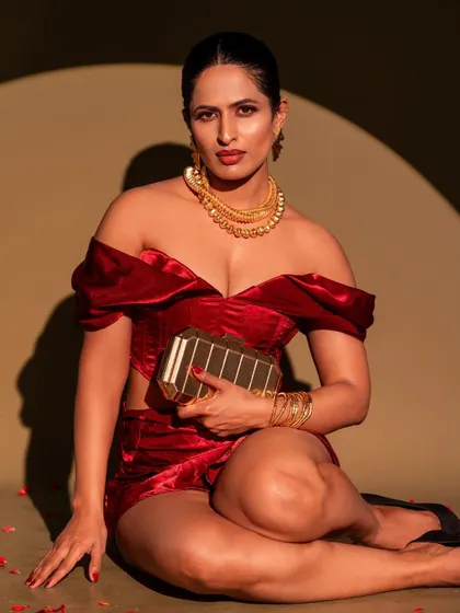 A bold and confident look for a modern event. This portrait features a custom red velvet co-ord set, paired with statement gold jewellery for a high-fashion feel.
