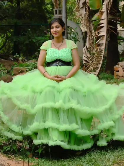 A full-length shot of the stunning lime green ruffled gown, perfect for an outdoor maternity shoot.