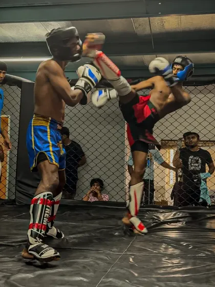 A perfectly timed high kick during a kickboxing match. This demonstrates the technical skill and athleticism we develop in our striking classes.