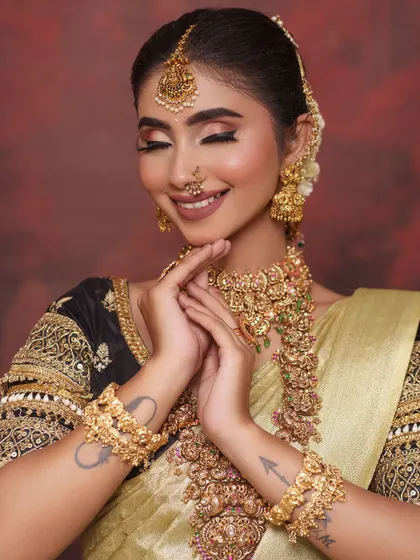 The joy of a bride feeling beautiful in her outfit. The tattoos on her arms add a personal and modern touch to the traditional ensemble.