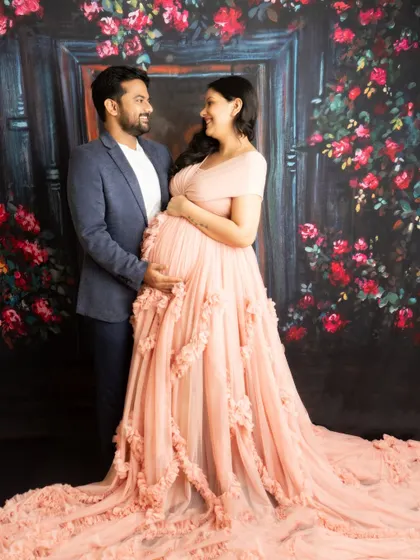 A classic couple's portrait against a romantic floral backdrop. The soft colors and gentle pose create a dreamy and elegant image.