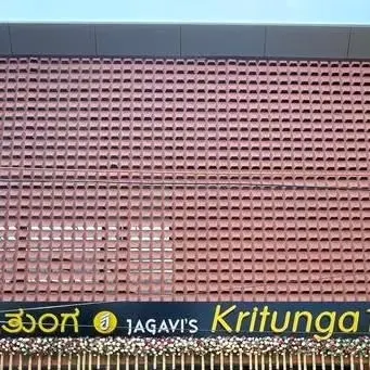 A direct frontal view of the restaurant's facade, showcasing the scale and detail of the custom brick screen. This architectural feature provides both visual interest and a degree of privacy for the interior space.