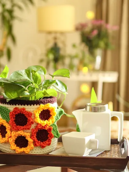Sunflowers make everything better. This basket, covered in cheerful crochet sunflowers, is perfect for holding a plant and bringing a bit of sunshine indoors.