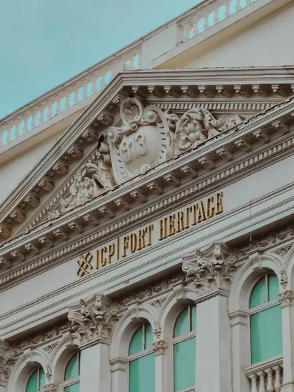 A close-up of the intricate carvings on the "Fort Heritage" building, showcasing the craftsmanship of a bygone era.
