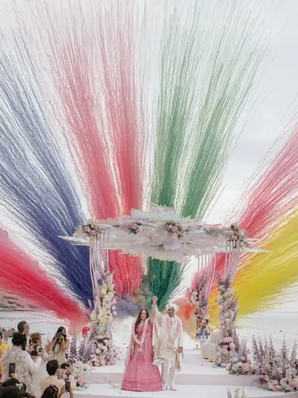 A spectacular moment of celebration as Roopali and Milap complete their pheras. The explosion of color against the serene beach backdrop in Ibiza captures the sheer joy and grandeur of a destination wedding, a story we love to tell through our lenses.