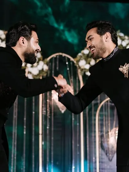 A candid moment of camaraderie between two performers. The sangeet is also about the bonds that are strengthened through dance.