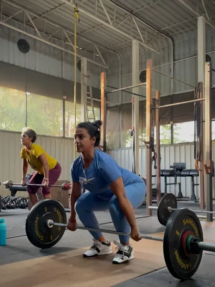 Performing a clean, a fundamental Olympic lift. I teach the technique from the ground up, ensuring you can perform these complex movements safely and efficiently.
