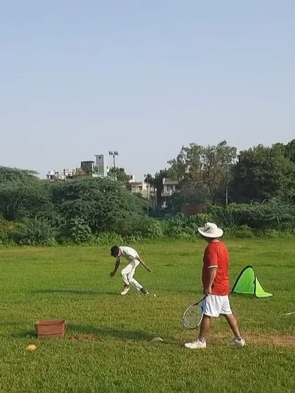 A coach oversees a fielding drill at our D I Khan ground. We use a variety of equipment like cones, hurdles, and ramps to simulate unpredictable ball movements and improve player reflexes.
